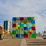 A multicolored building sitting on the side of a road
